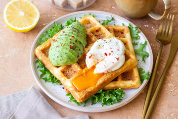 Belgian waffles with avocado and poached egg. Healthy eating. Vegetarian food. Breakfast.