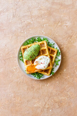 Belgian waffles with avocado and poached egg. Healthy eating. Vegetarian food. Breakfast.
