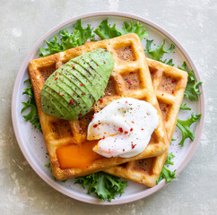 Belgian waffles with avocado and poached egg. Healthy eating. Vegetarian food. Breakfast.