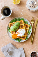 Belgian waffles with avocado and poached egg. Healthy eating. Vegetarian food. Breakfast.