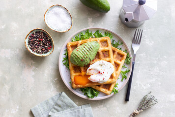 Belgian waffles with avocado and poached egg. Healthy eating. Vegetarian food. Breakfast.