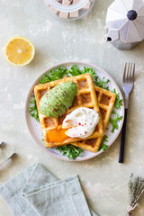 Belgian waffles with avocado and poached egg. Healthy eating. Vegetarian food. Breakfast.