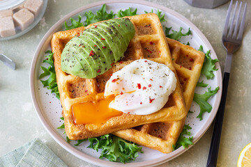 Belgian waffles with avocado and poached egg. Healthy eating. Vegetarian food. Breakfast.