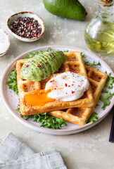 Belgian waffles with avocado and poached egg. Healthy eating. Vegetarian food. Breakfast.