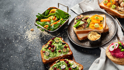 Vegan toast with avocado,mushroom and fresh salad on dark background. Vegetarian food concept