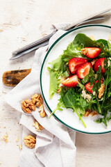 Fresh dandelion salad on light background. Edible plant and nectariferous.