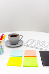 Office desk table with computer,  mobile phone, supplies, sticky notes, coffee  and coloured pens. Top view with copy space. Flat lay. Time management.  
