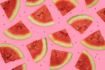 Summer fruit background concept, many cuts of red seeded watermelon on pink background