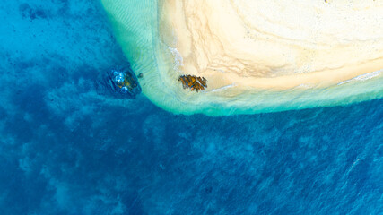 Top view nature of beach and sea Summer with sunshine, sandy beaches, clear blue waters sparkling against the blue sky. On an island with good ecology and environment Background for summer vacation