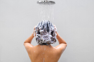 Beautiful woman's hand She was washing her hair and nourishing her scalp. Shampoo and conditioner	