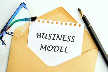 BUSINESS MODEL - Concept of text an inscription on a piece of paper peeking out of an envelope next...