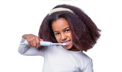 Healthy teeth, toothpaste. Small girl, toothbrush. Multiracial girl brushes her teeth an electric toothbrush. Little girl toothbrush closeup. Little cute african american girl brushing her teeth