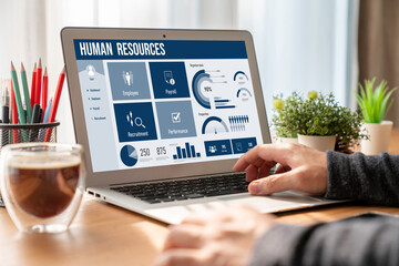 Human resources management software on computer screen helping human resources employee to manage...