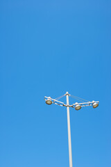 Close-up of a metal street lamp with clear blue sky
