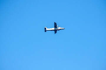 Propeller plane is flying on isolated blue sky