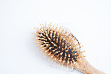 Hair loss fall with comb brush isolated on white background.