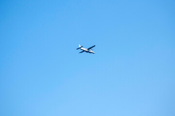 Propeller plane is flying on isolated blue sky