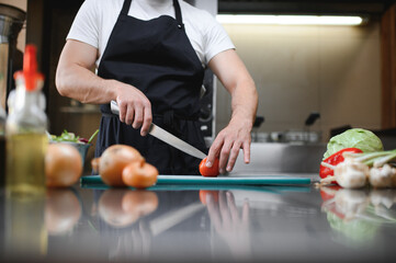 Chef cook preparing vegetables in his kitchen