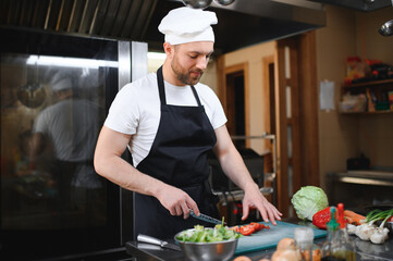 Chef cook preparing vegetables in his kitchen