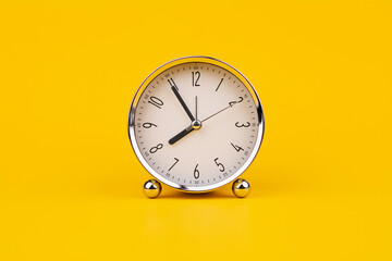 Time and work, the clock stops, the minute hand stops moving, a photo of a clock on a yellow...