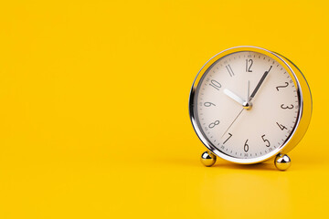 Time and work, the clock stops, the minute hand stops moving, a photo of a clock on a yellow...
