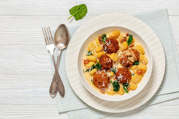 tuscan chicken meatballs with gnocchi in a bowl