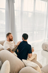 Two men, a happy gay couple, relax on a modern living room couch, enveloped in love and...