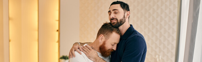 Obraz premium Two men, a happy gay couple, embrace in a room filled with warmth and love, sharing a tender moment of connection.