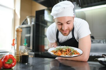 Gourmet chef in uniform cooking in a commercial kitchen