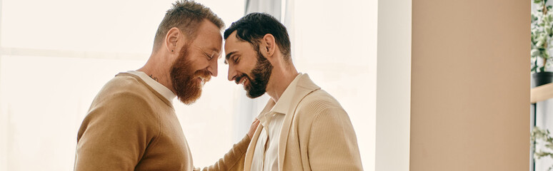 Two men in a modern apartment make eye contact, displaying love and connection in their...