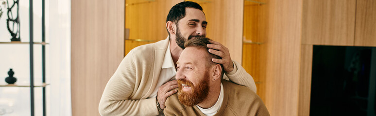 Fototapeta premium Two men embrace tenderly in a cozy home, displaying affection and closeness in their relationship.