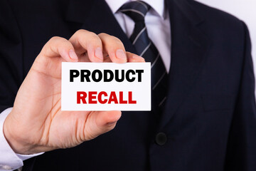 Businessman holding a card with text Product recall