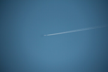 The flight of airplanes and the line behind them, which is known as the cantrail, in the sky of the Kurdistan province of Iran