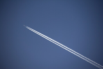 The flight of airplanes and the line behind them, which is known as the cantrail, in the sky of the Kurdistan province of Iran