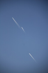 The flight of airplanes and the line behind them, which is known as the cantrail, in the sky of the Kurdistan province of Iran