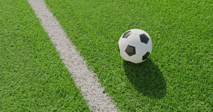 Soccer field impressions  - A panning shot showing a soccer ball lying on a soccer field next to one of the marking lines