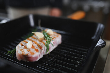 grilled pork steaks in a grill pan with spices