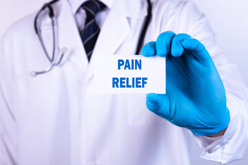 Doctor holding a card with text Pain Relief medical concept