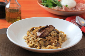Grilled Foie gras steak with with Fettuccine pasta on restaurant table