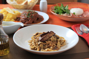 Grilled Foie gras steak with with Fettuccine pasta on restaurant table