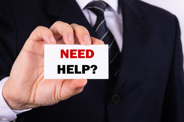 Businessman holding a card with text need help