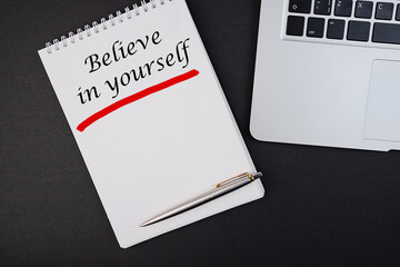 Business concept - Top view notebook writing Believe in yourself