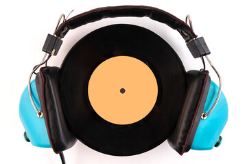 Vinyl record and headphone on a white background. Audio enthusiast, music lover or professional DJ...
