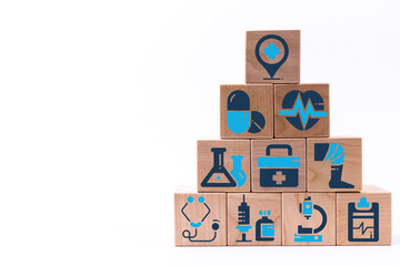 Pyramid of wooden blocks with healthcare medical icons. Insurance your health concept.