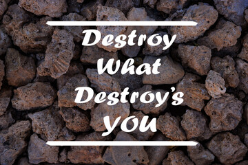 Inspirational motivational quote - Destroy what destroys you written on a stone wall.