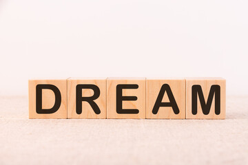 Word Dream is written on wooden blocks on a light background.