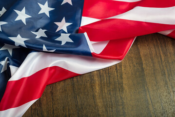 Close up of a United States flag on a wooden table. Copy space.