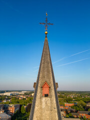 Aerial view of a church steeple with a cross in a suburban area, displaying architectural beauty...