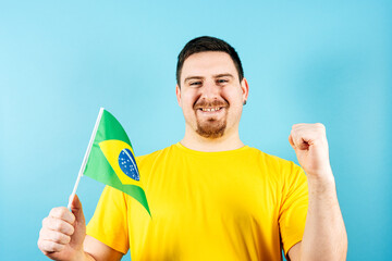 Man holding Brazil flag cheering in support of national football team
