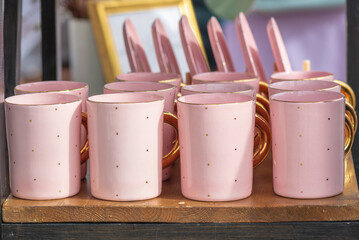Group pink porcelain mugs on the table.